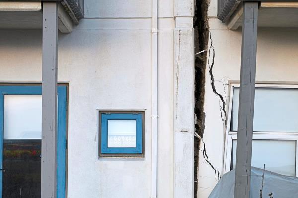 A crack appears on the facade of a house in Grindavik, after being hit by earthquakes.